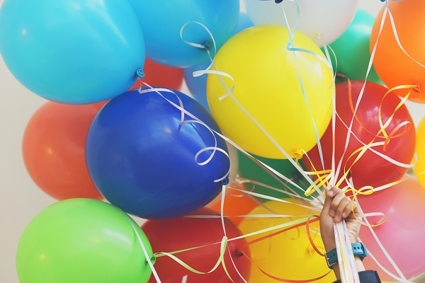 Multiple colourfull balloons against a blue sky